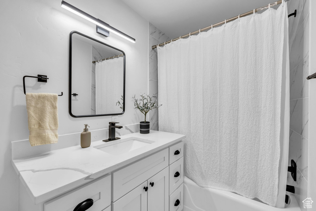 Bathroom featuring shower / bath combo and vanity