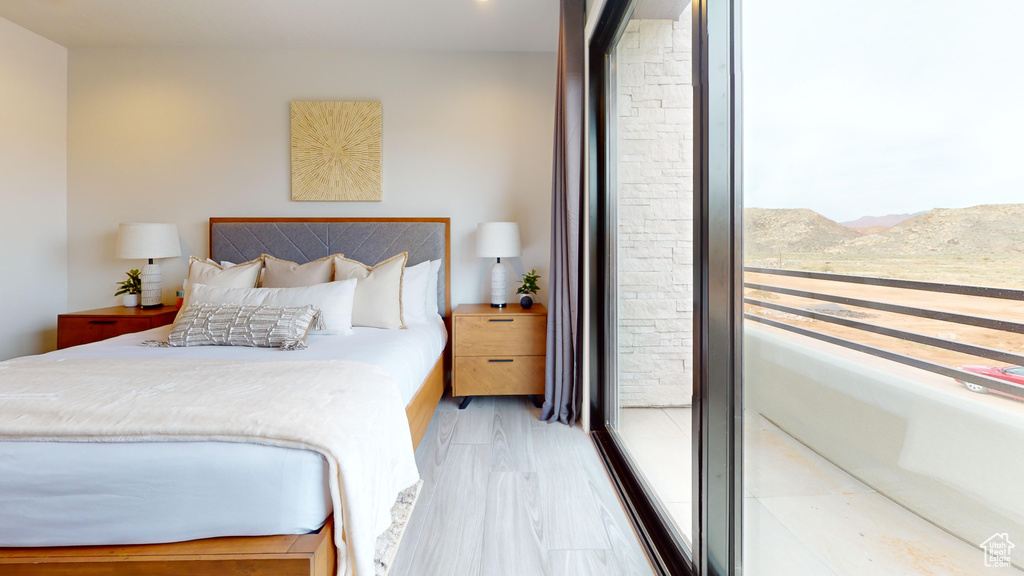 Bedroom featuring light hardwood / wood-style flooring and multiple windows