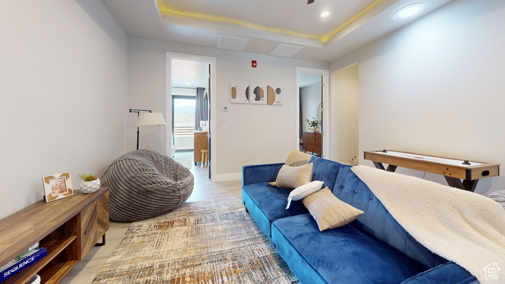 Interior space with light wood-type flooring and a raised ceiling