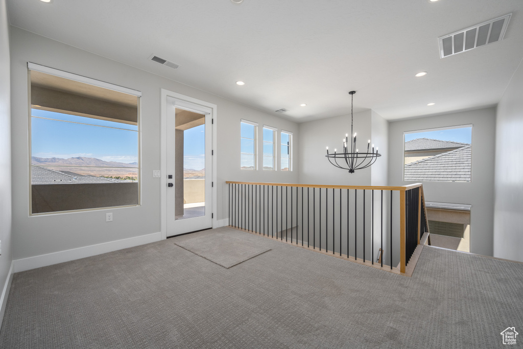 Interior space featuring an inviting chandelier and carpet