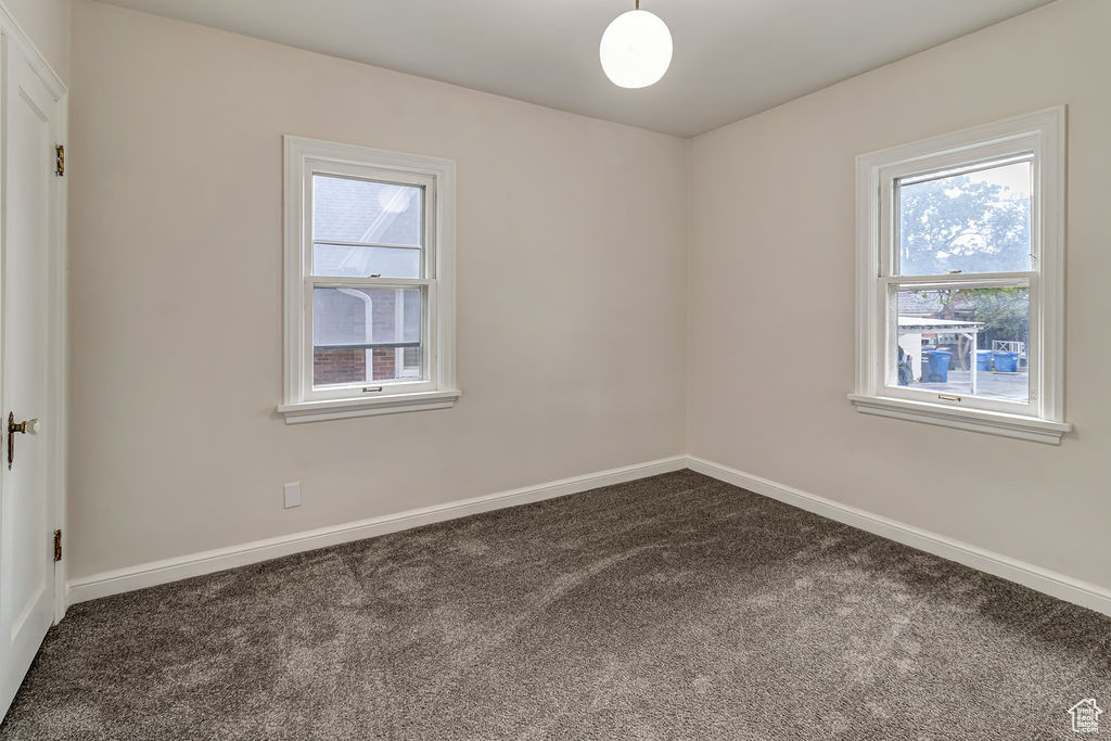 Carpeted empty room with a healthy amount of sunlight