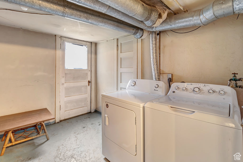 Clothes washing area featuring washer and dryer