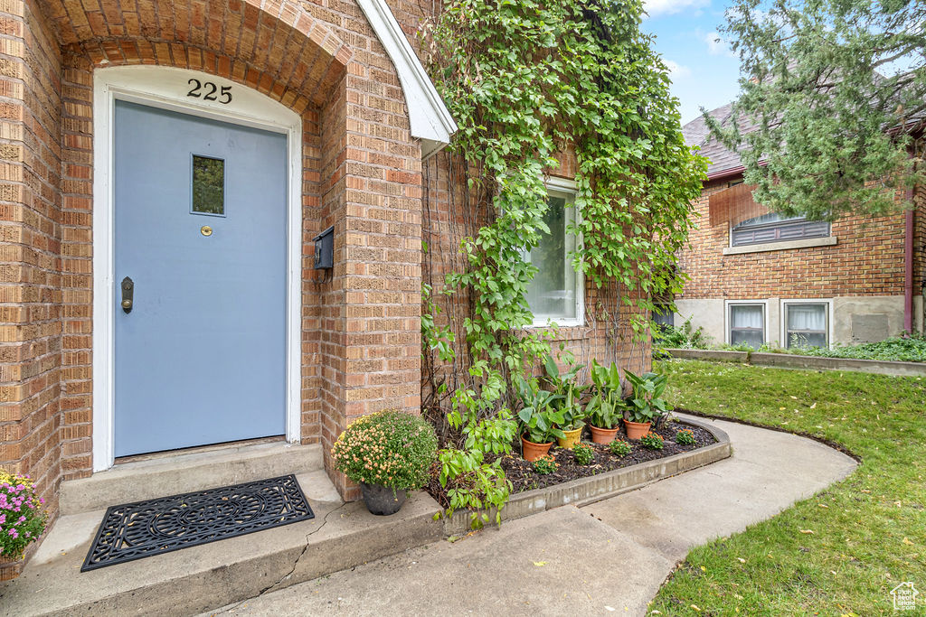 Doorway to property featuring a yard