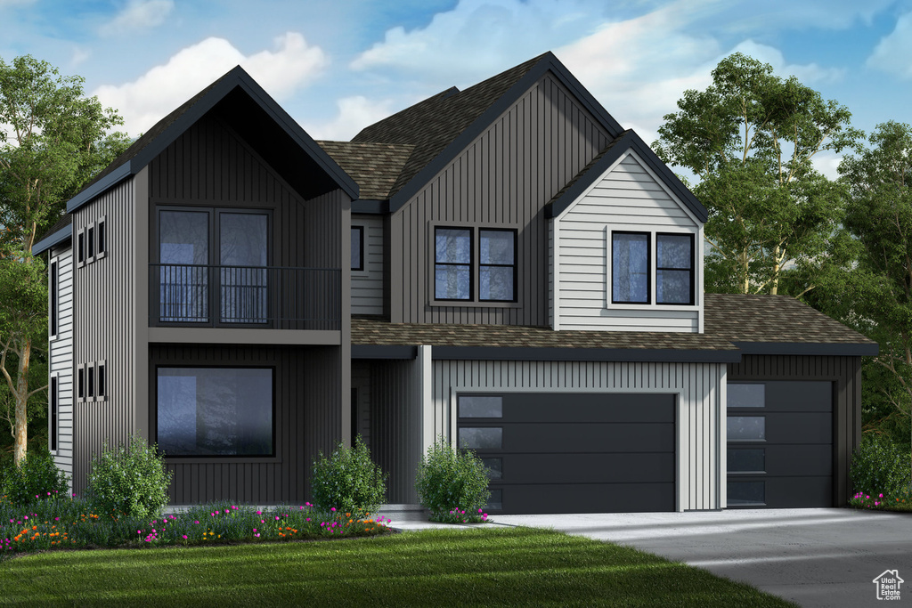 View of front of home featuring a front yard and a garage