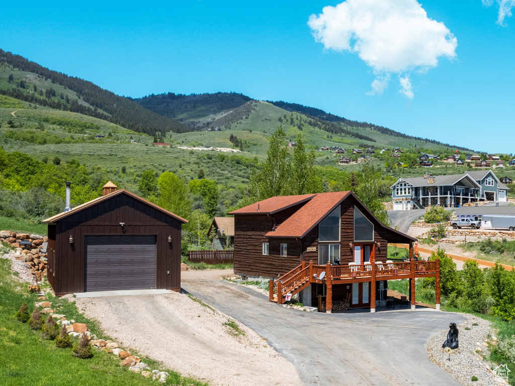 Aerial view of property and surrounding area featuring a mountain backdrop