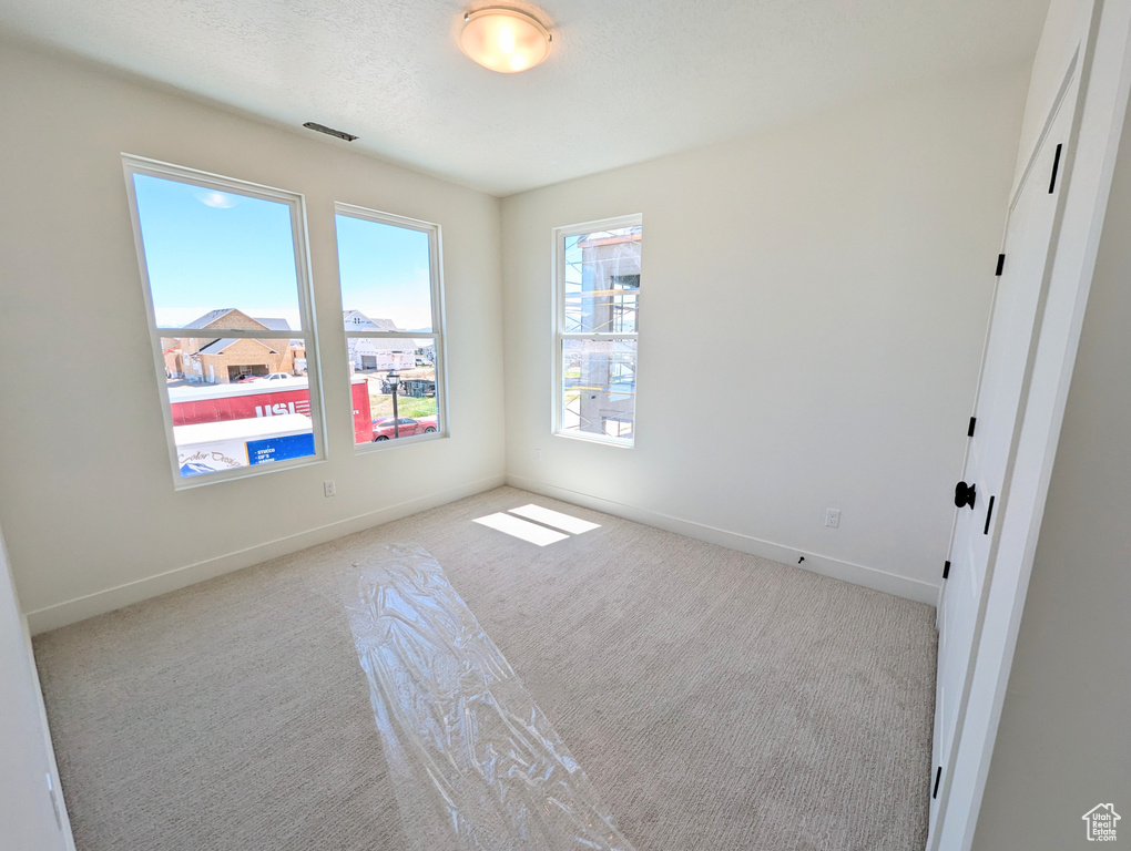 Spare room featuring light colored carpet