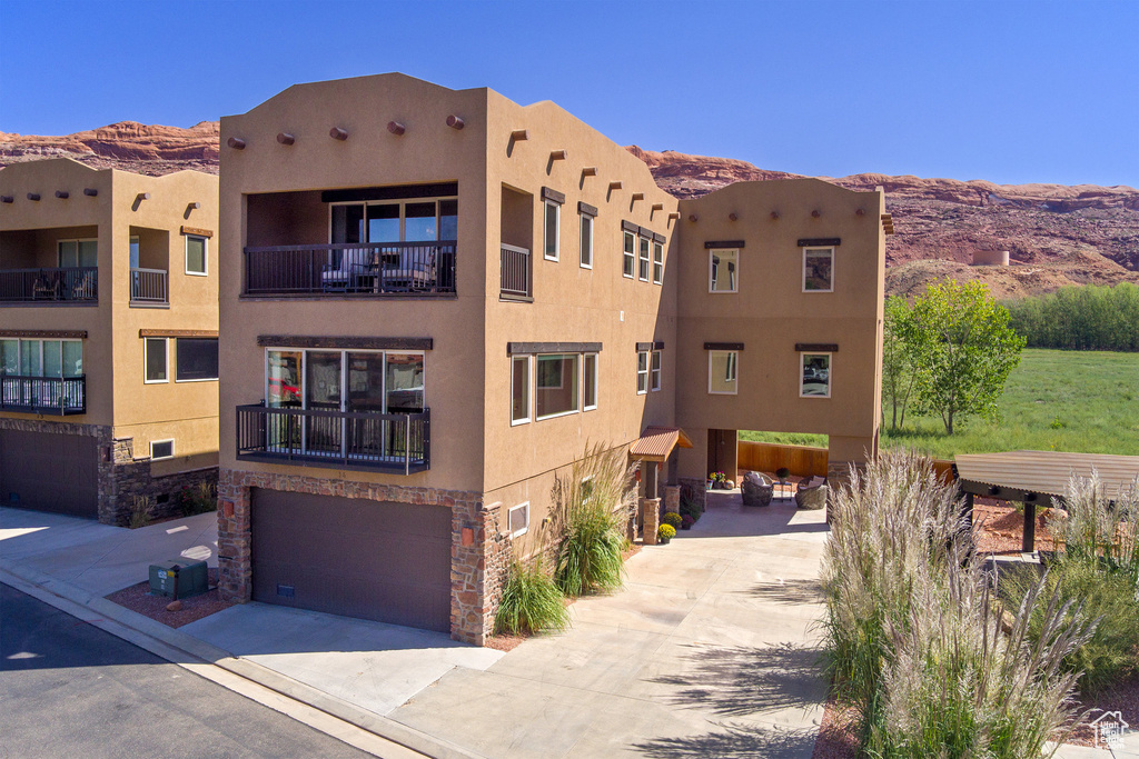 View of building exterior featuring a mountain view and a garage