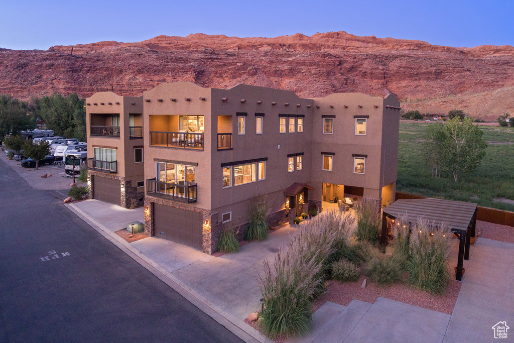 View of property featuring a mountain view and a garage