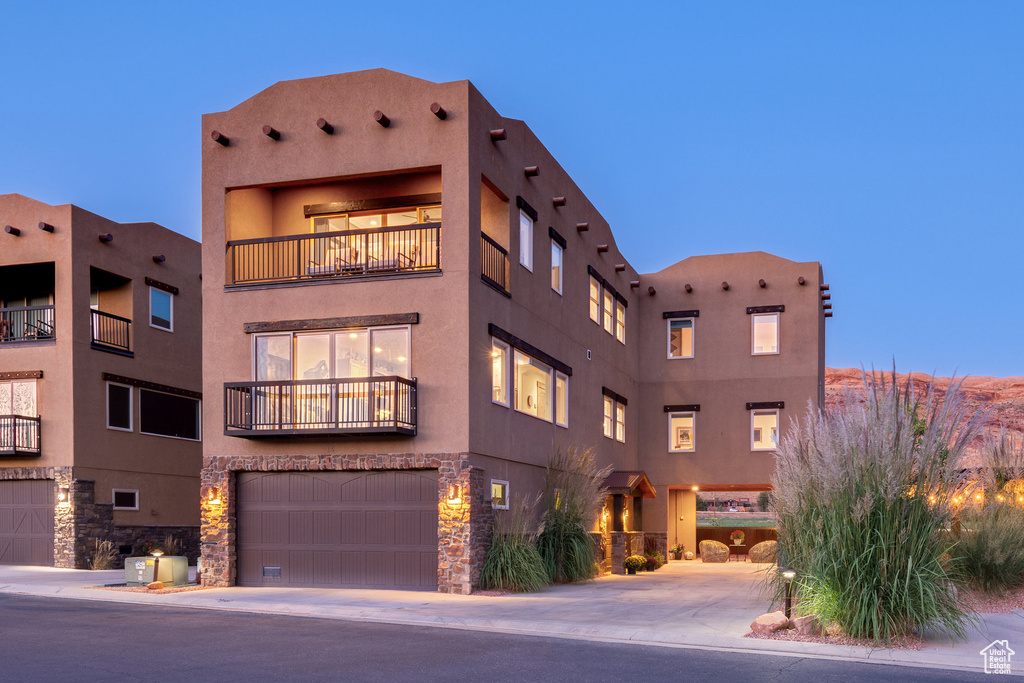 Outdoor building at dusk featuring a garage