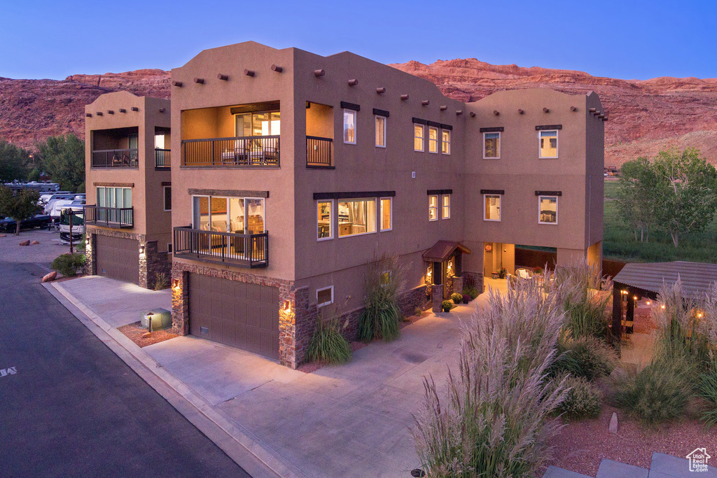 View of building exterior with a garage and a mountain view