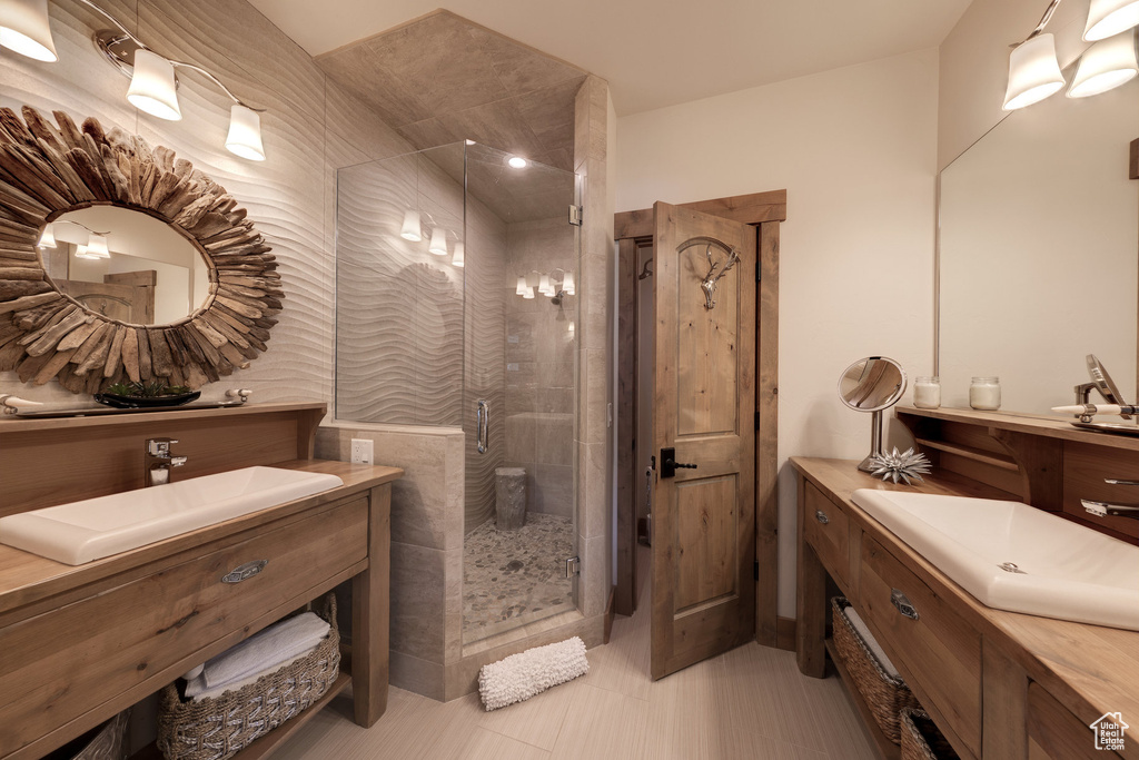 Bathroom featuring tile walls, vanity, tile patterned floors, and an enclosed shower