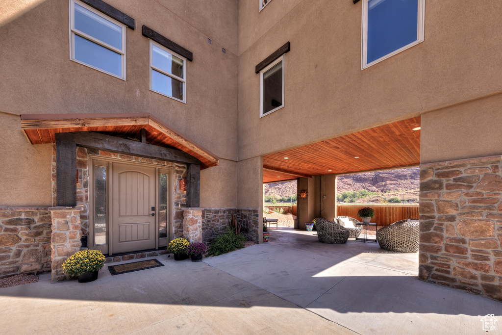 Doorway to property with a patio area