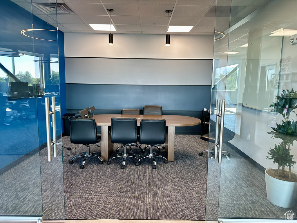 Carpeted office space with a drop ceiling