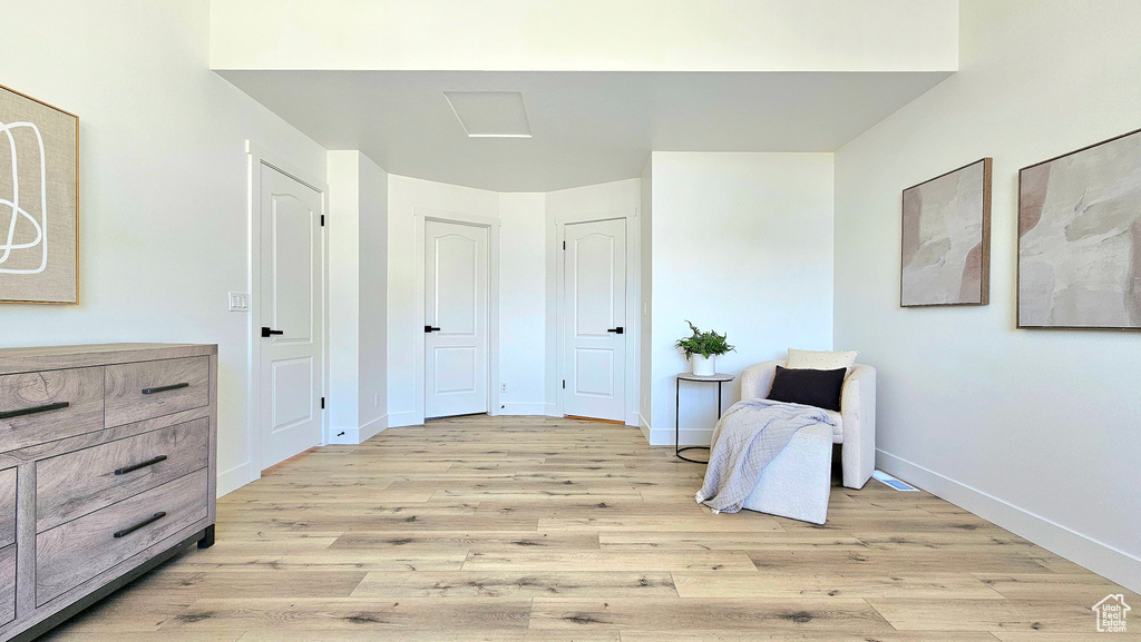 Sitting room with light hardwood / wood-style flooring