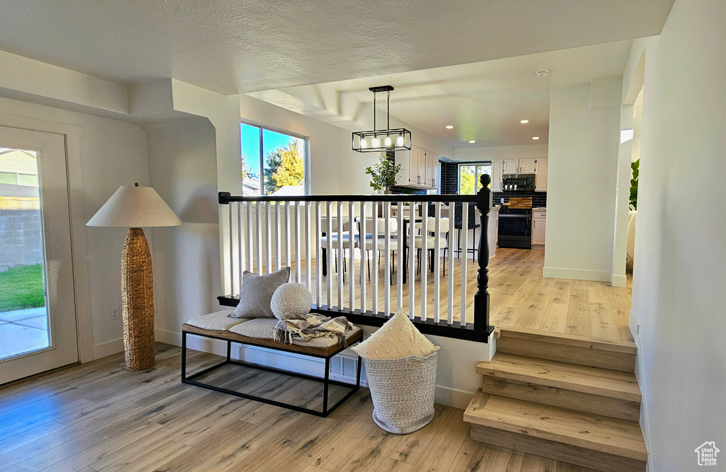 Living area featuring a wealth of natural light, light hardwood / wood-style floors, and a textured ceiling