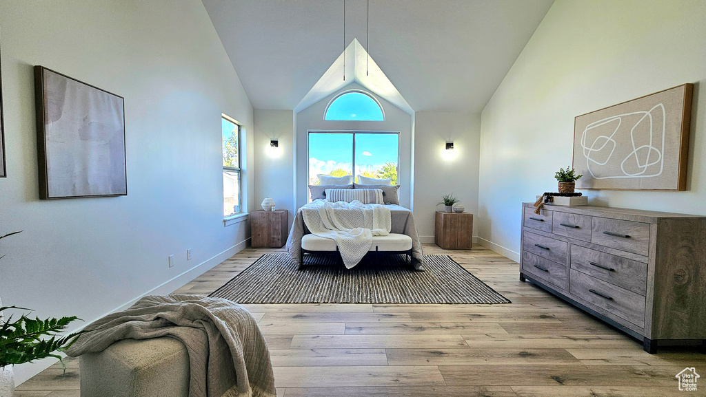 Bedroom featuring light hardwood / wood-style flooring and vaulted ceiling