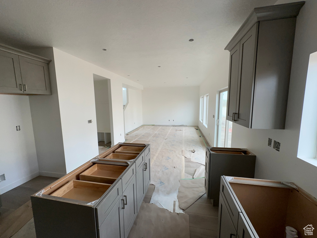 Kitchen featuring gray cabinets and a kitchen island