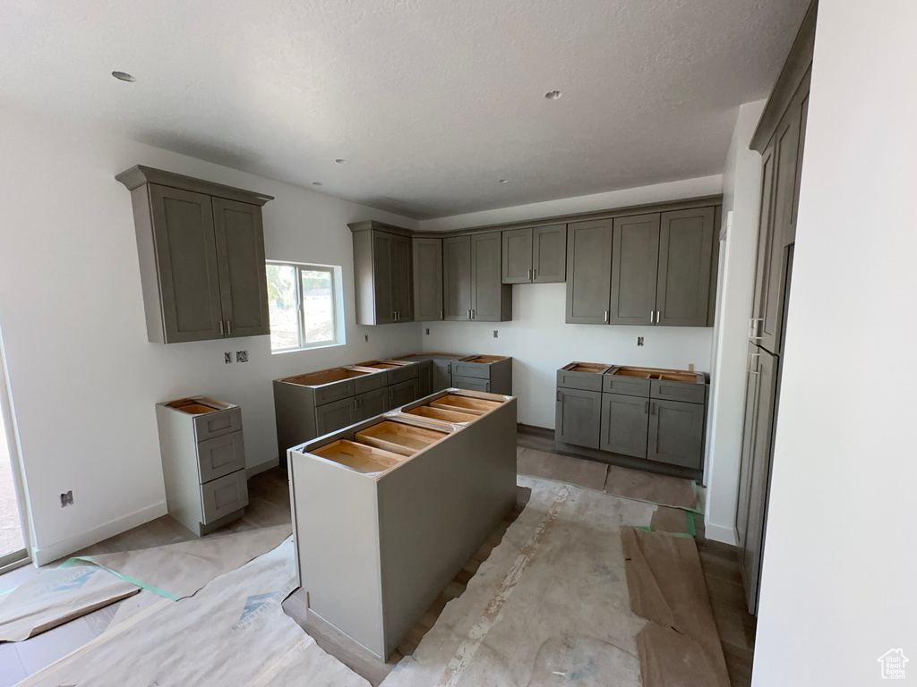 Kitchen featuring a textured ceiling and gray cabinets