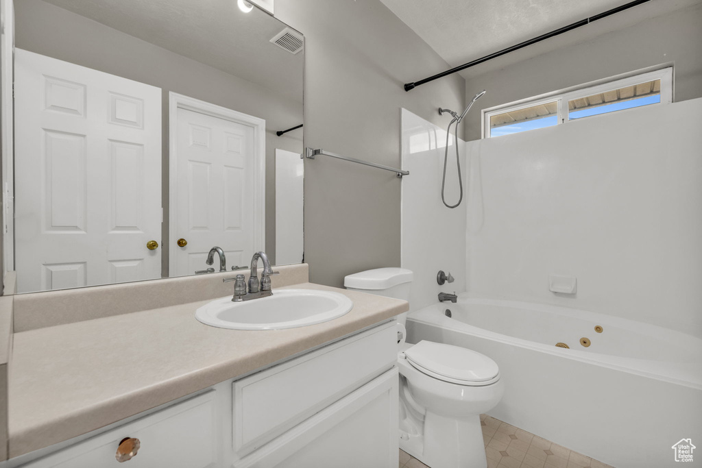 Full bathroom featuring bathing tub / shower combination, vanity, and toilet