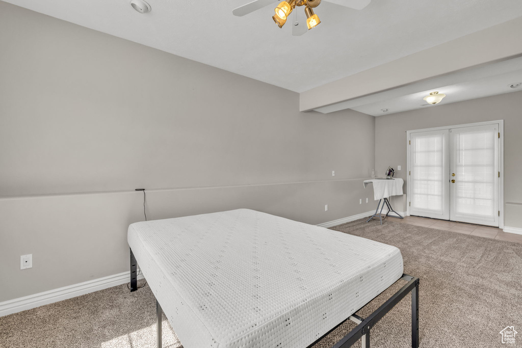 Carpeted bedroom with ceiling fan