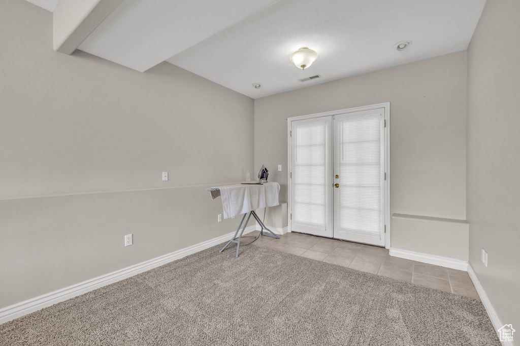 Spare room with light colored carpet