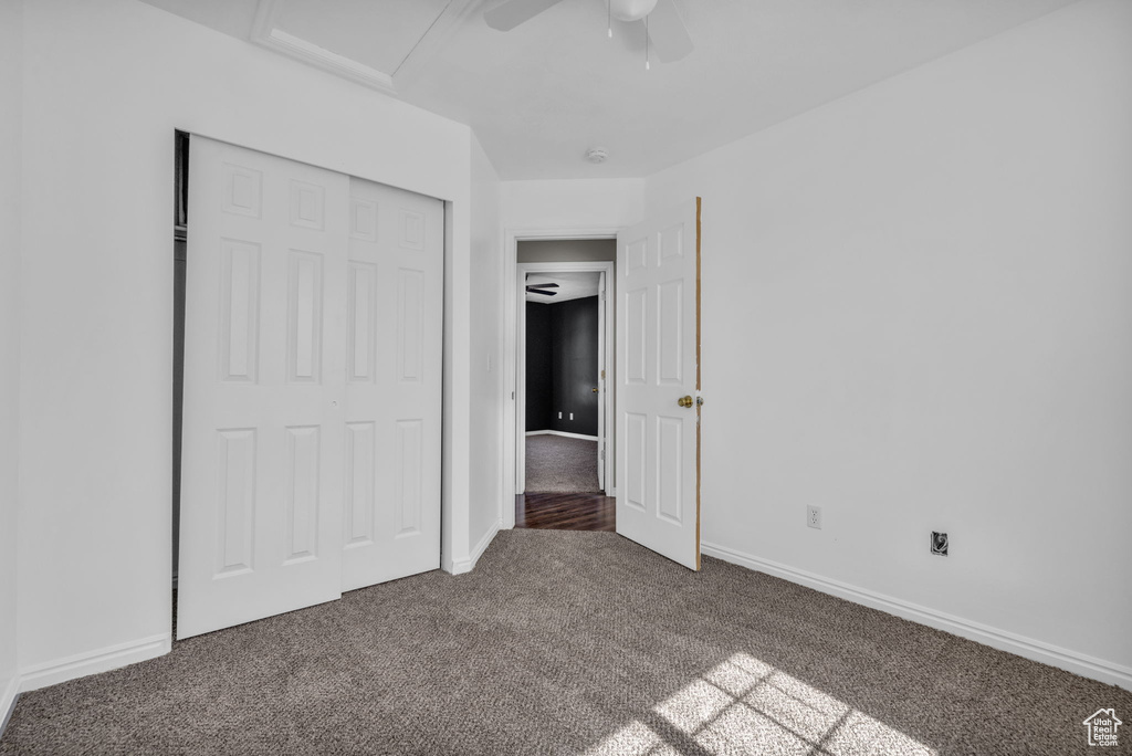 Unfurnished bedroom featuring carpet floors, a closet, and ceiling fan