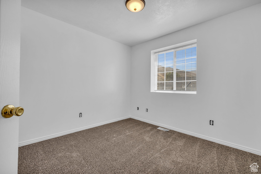 Spare room featuring carpet floors