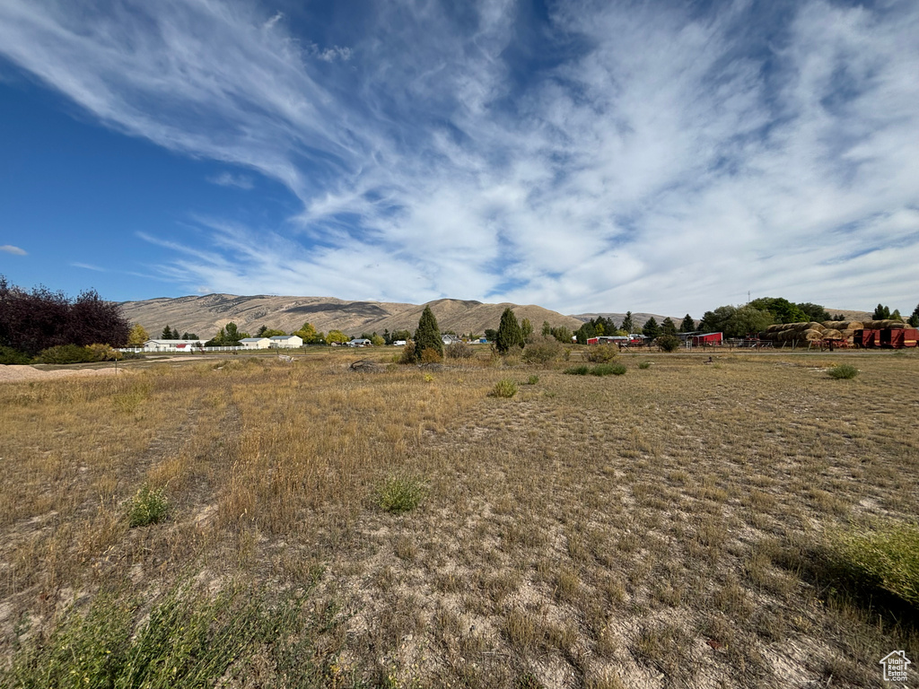 View of yard with a rural view and a mountain view
