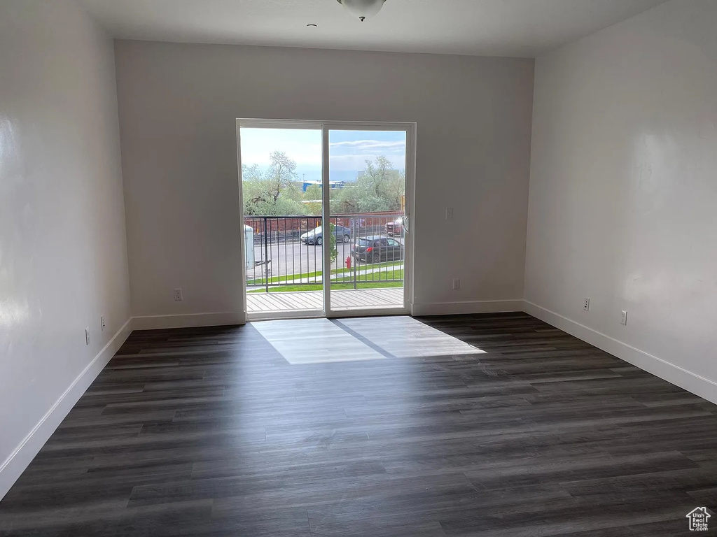 Unfurnished room featuring dark wood-type flooring