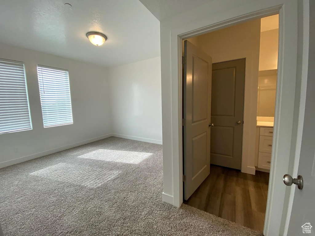 Unfurnished room with dark colored carpet