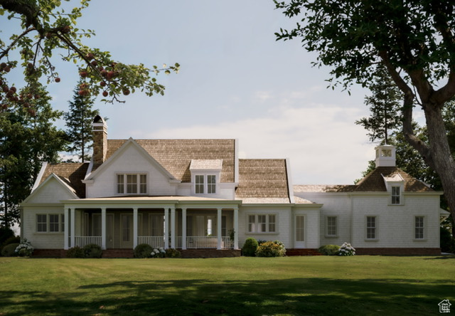 View of front of house with a front lawn and a sunroom