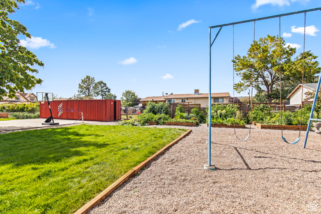 Surrounding community featuring a playground and a yard