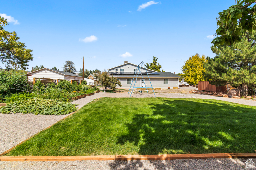 Rear view of house featuring a lawn