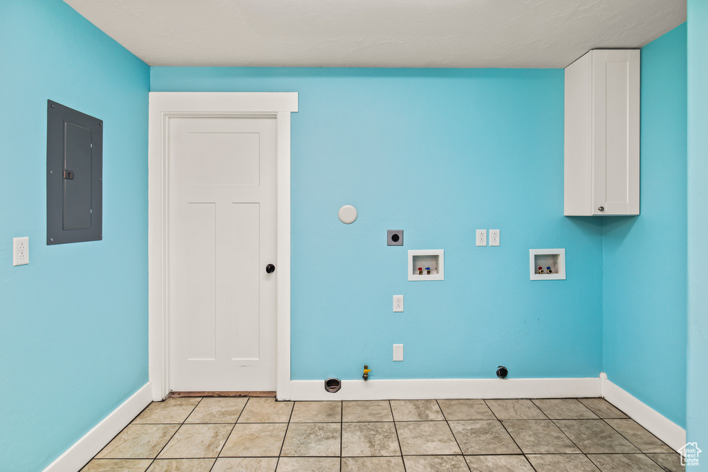 Clothes washing area featuring light tile patterned flooring, washer hookup, hookup for an electric dryer, gas dryer hookup, and electric panel