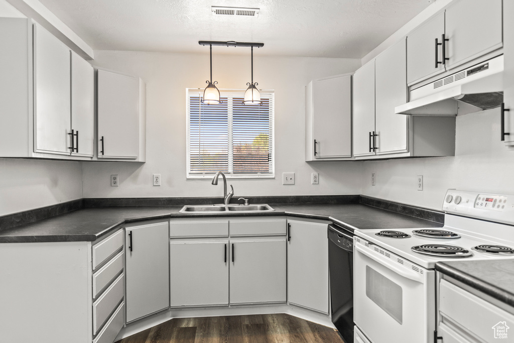 Kitchen with white cabinets, white electric range oven, dark wood-type flooring, and sink