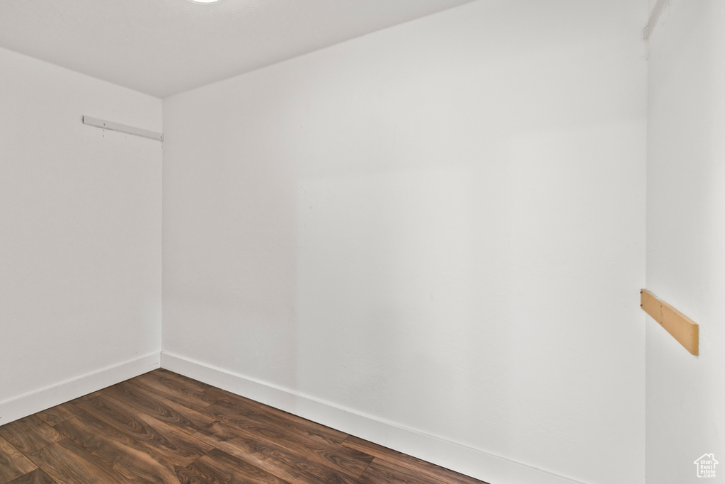 Unfurnished room featuring dark wood-type flooring