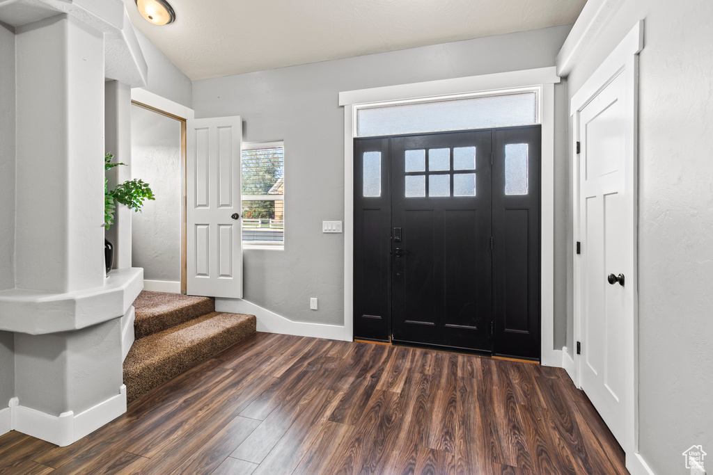 Foyer entrance with dark hardwood / wood-style floors