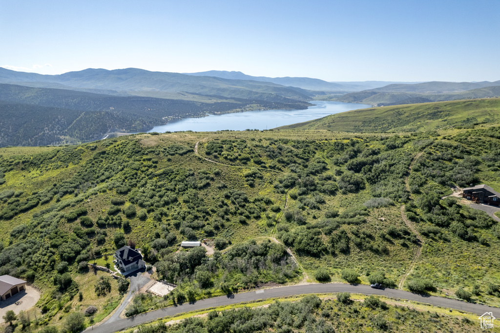 Birds eye view of property with a water and mountain view