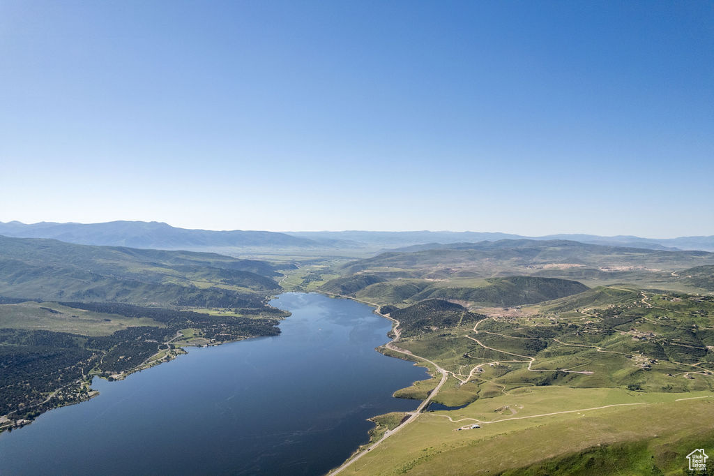 Birds eye view of property featuring a water and mountain view