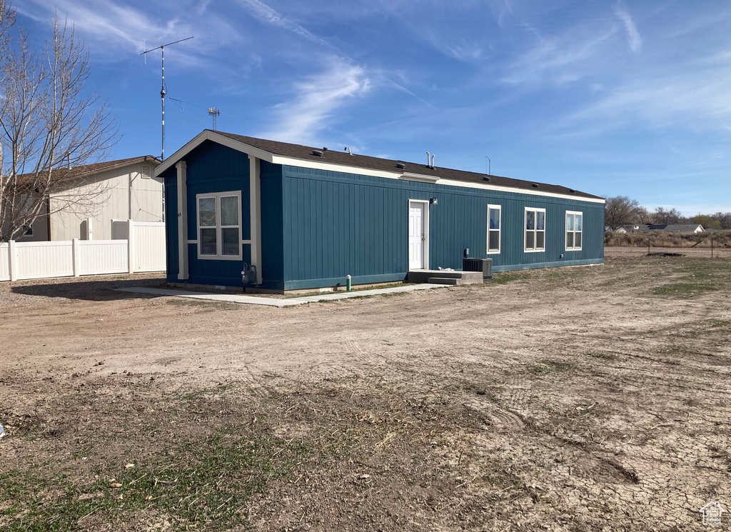 Rear view of property with central air condition unit