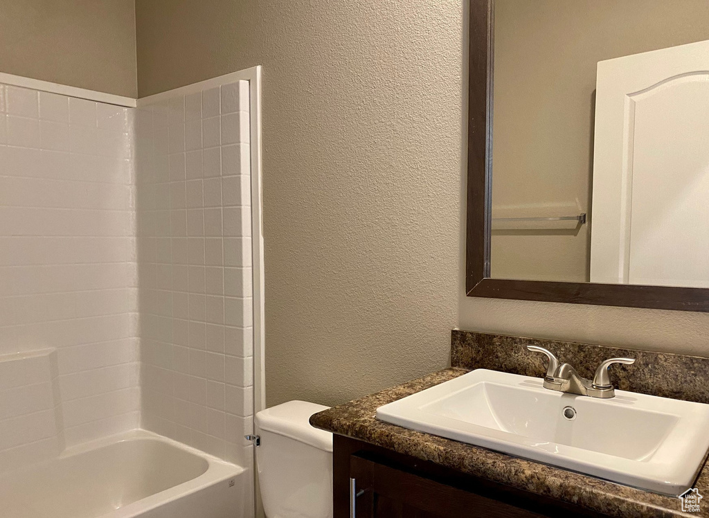 Full bathroom featuring vanity, toilet, and shower / washtub combination