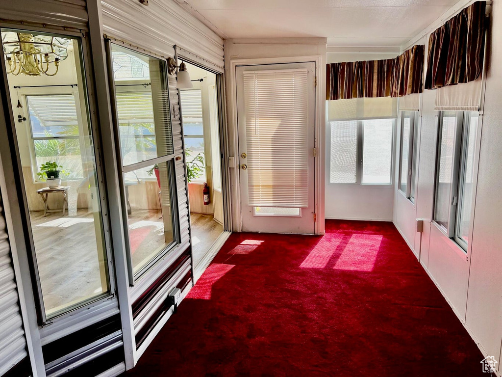 Interior space with a notable chandelier and plenty of natural light