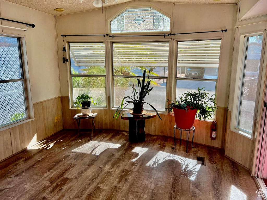 Unfurnished sunroom with a healthy amount of sunlight and vaulted ceiling