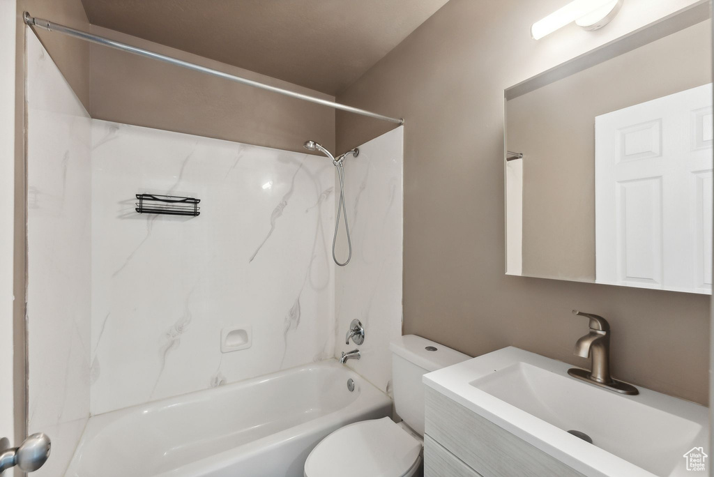 Full bathroom with tub / shower combination, vanity, and toilet