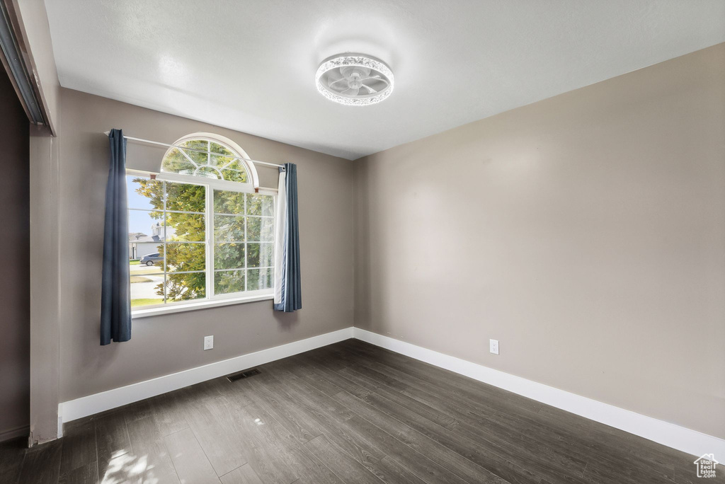 Unfurnished room featuring dark hardwood / wood-style flooring