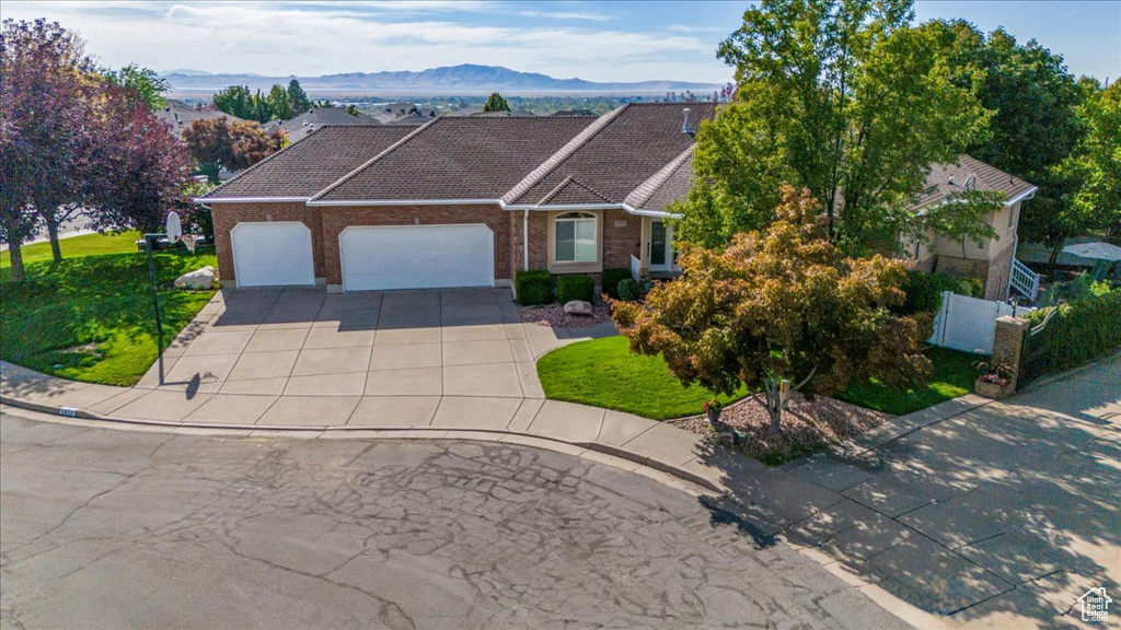 Ranch-style home featuring a mountain view and a garage