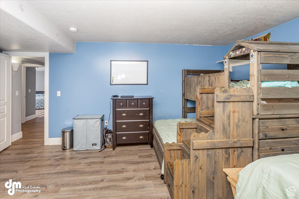 Bedroom with wood-type flooring and a textured ceiling