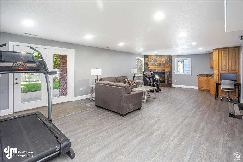 Living room with light wood-type flooring and a fireplace