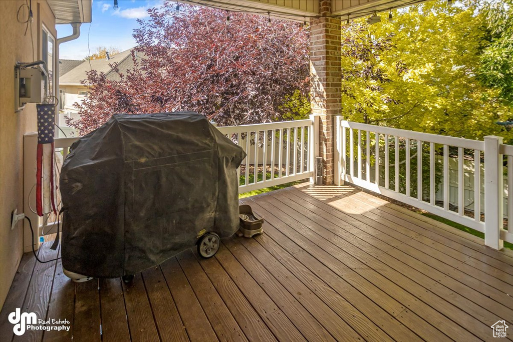 Wooden deck featuring area for grilling