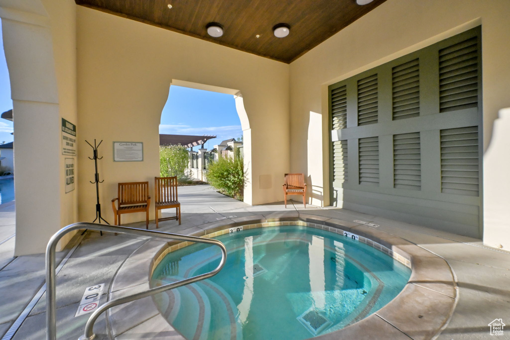 View of pool featuring a patio and a community hot tub